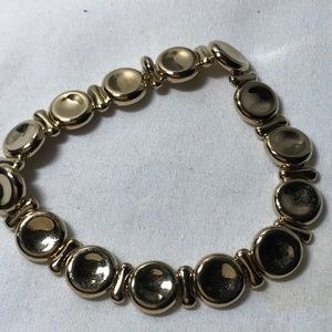 Monet bracelet in gold tone, measures 8 in, round accents, signed piece